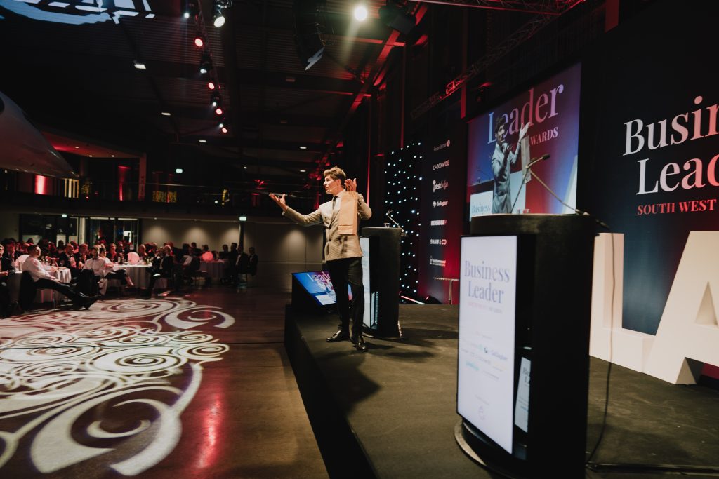 Ben Hanlin teaching business communication skills on stage