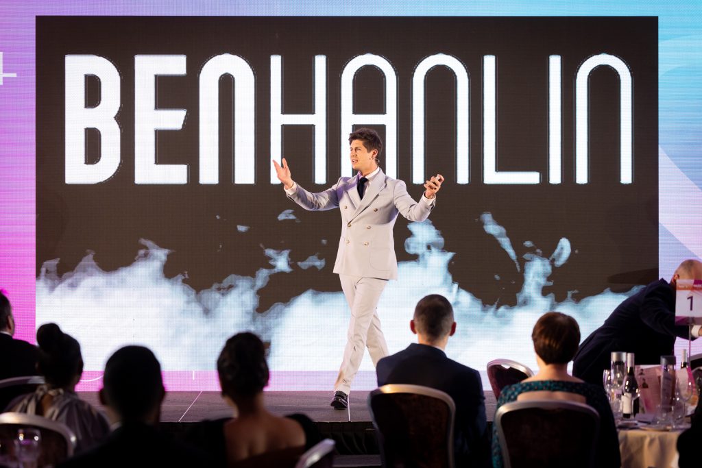 Ben Hanlin communication skills speaker walking the stage to build confidence before a talk.