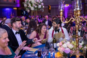 Fun fundraising event – audience enjoying charity gala hosted by Ben Hanlin.