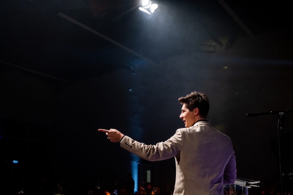 Ben Hanlin sharing tips for public speaking on stage without slides to improve stage presence.