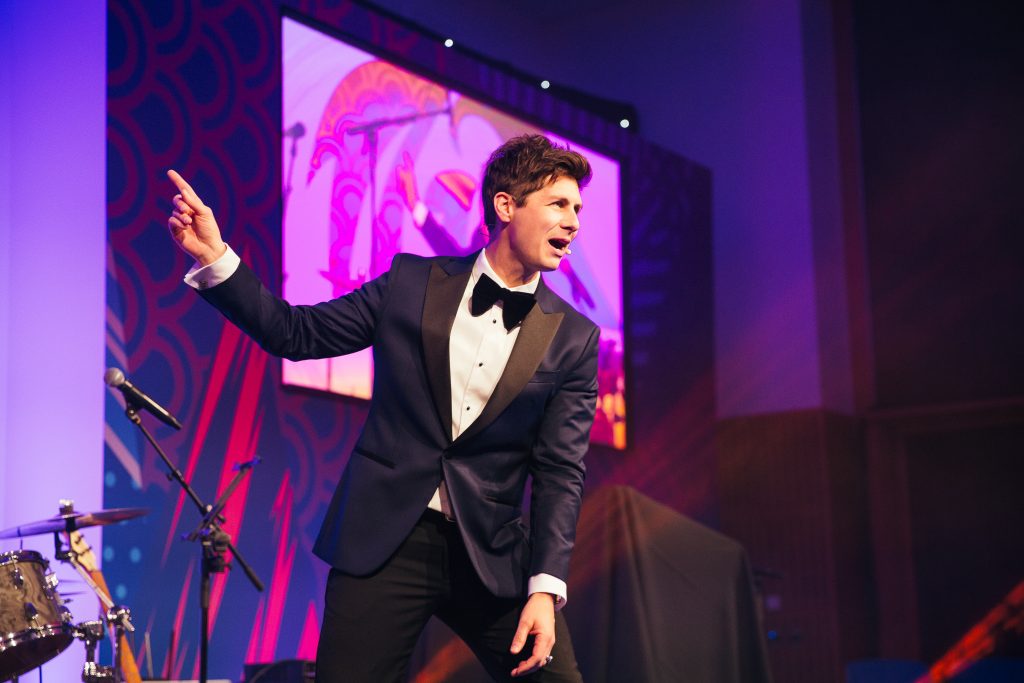 Ben Hanlin awards host UK keeping the audience engaged on stage.