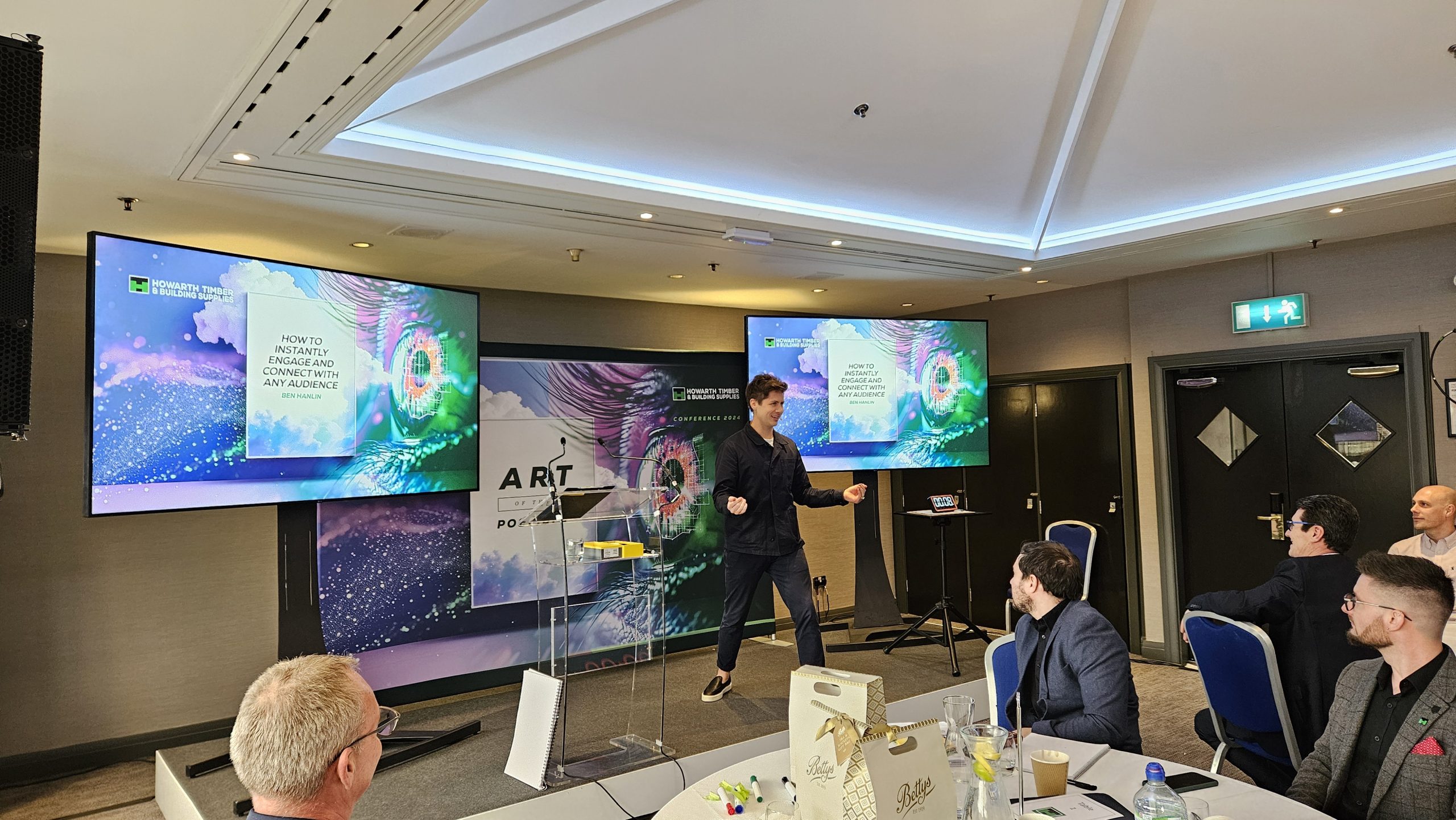 Ben Hanlin greeting someone at an event while using name recall techniques to improve business communication skills.