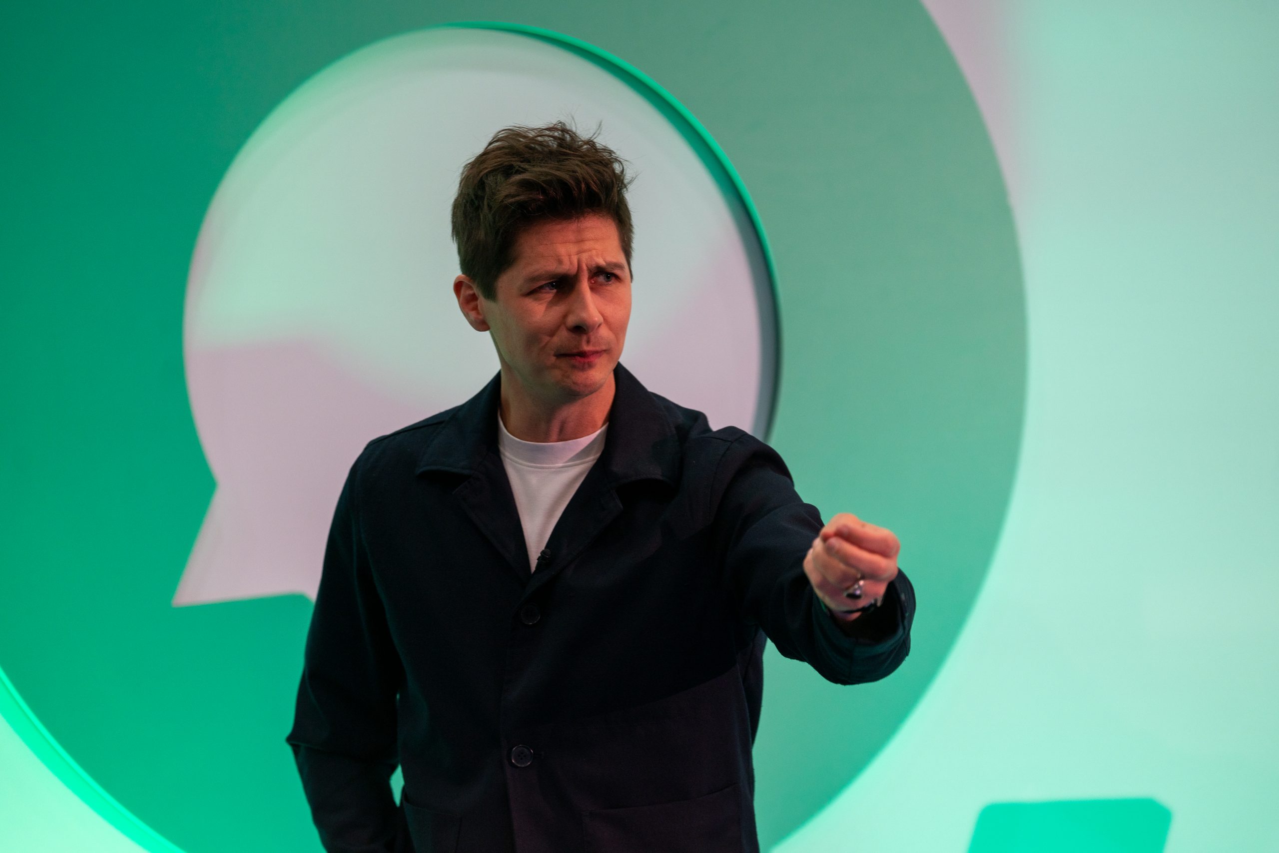 Ben Hanlin presenting on stage, demonstrating Gear Changes to keep an audience engaged.