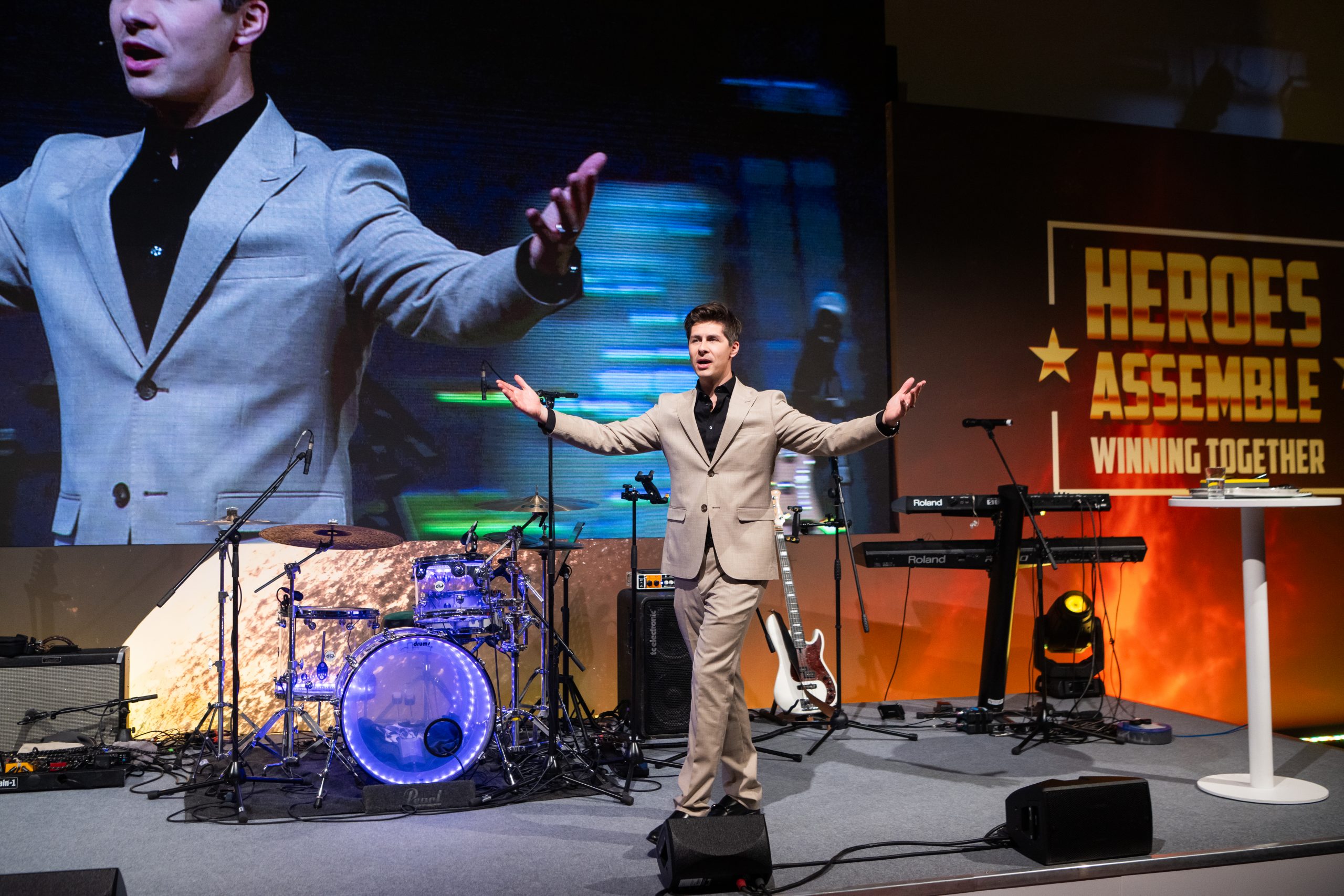 Ben Hanlin hosting an awards ceremony on stage, engaging the audience with humour and energy.