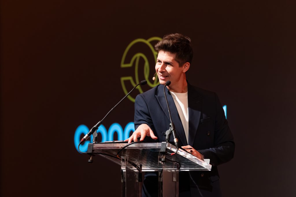 Ben Hanlin opening a presentation with confident body language, eye contact, and a genuine smile.